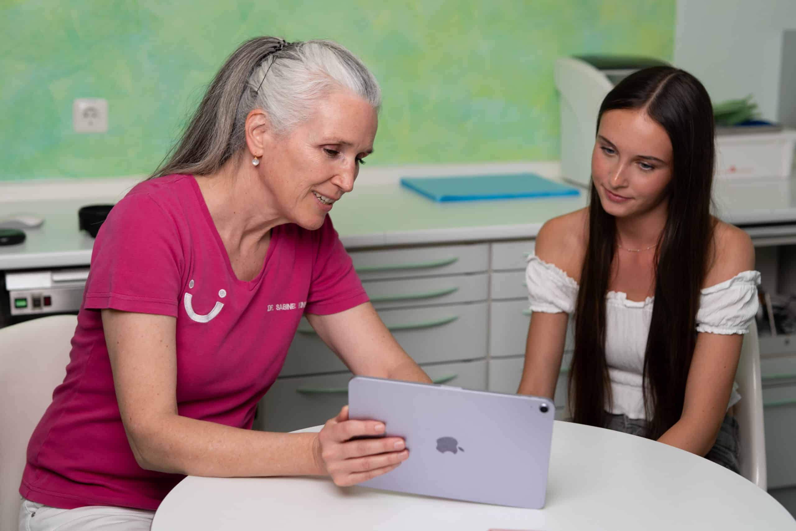 Aligner-Spezialistin Dr. Kinner berät ein junges Mädchen zu ihrer Zahnkorrektur